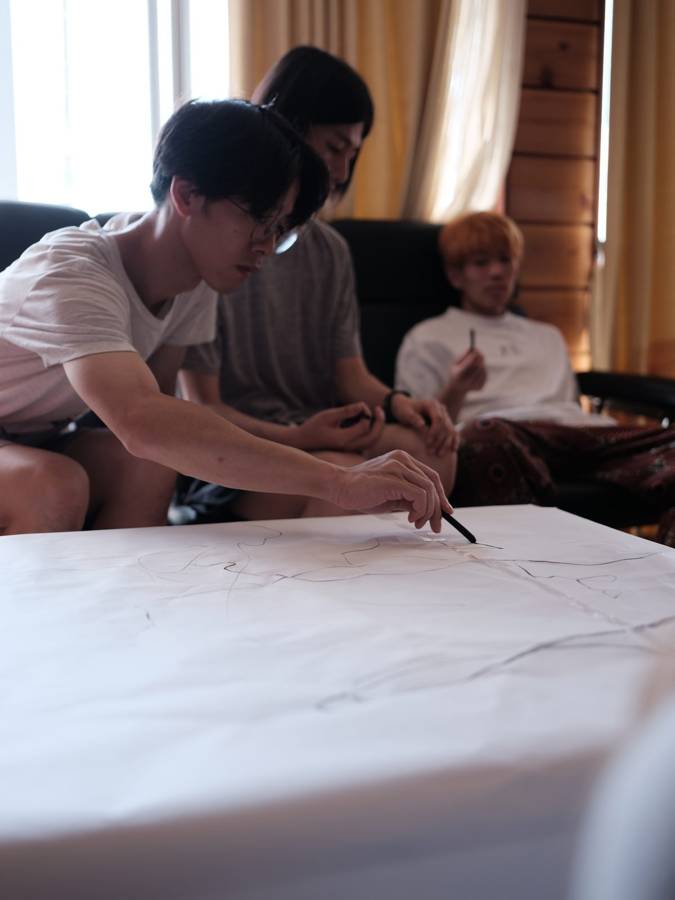 Drawing on a big sheet of paper