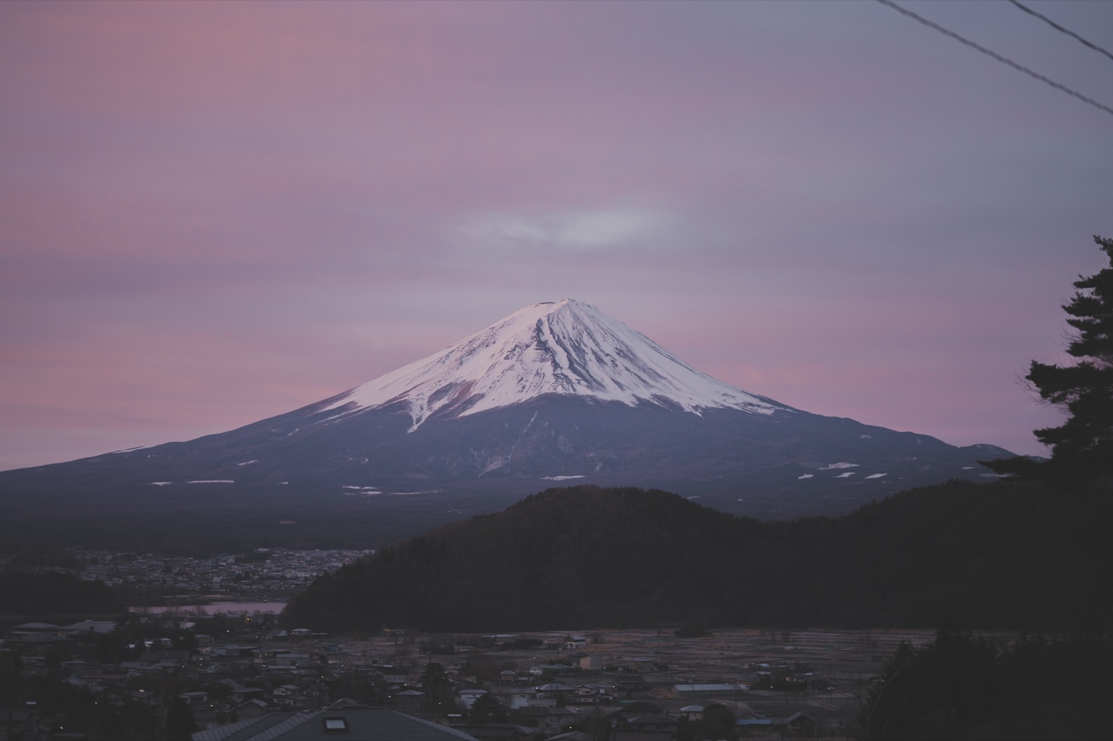 Mt. Fuji rising over the village at dusk